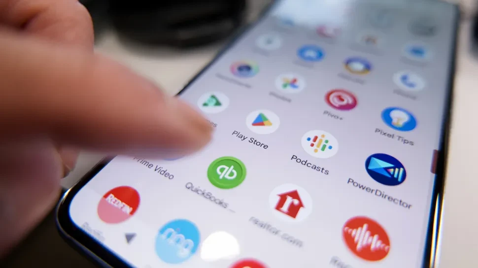 Finger about to click on Google Play app on Android phone.